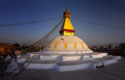 Sunset over the ancient stupa, one of the largest in the world and a social center for Tibetan Buddhism in Nepal.
